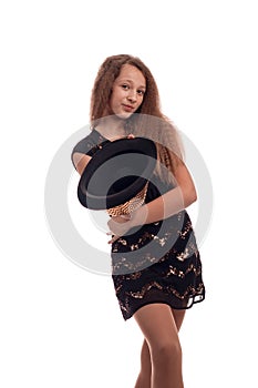 Young girl with long hair wearing a black dress and gold hat on a white background