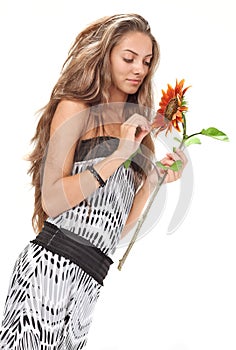 Young girl with long hairs holding sunflower