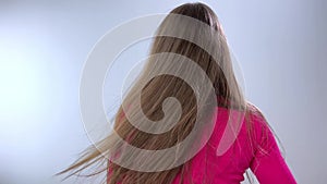Young girl with long straight brown hair turns and shows 2 fingers up woman beautiful positive cute model girl posing