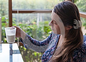 Young girl lookÄ±ng at a cup of flour