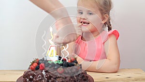 Young girl looking at cake