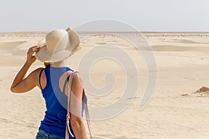 Young girl looking into distance in Sahara Desert, Tunisia, Africa