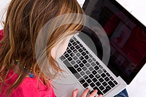 Young girl looking at laptop screen