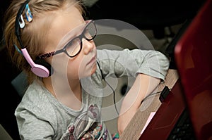Young girl looking at laptop screen