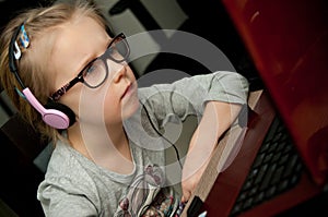 Young girl looking at laptop screen