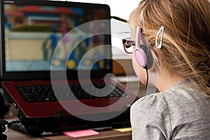 Young girl looking at laptop screen