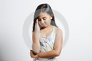 Young girl looking sad over white background
