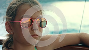 Young girl looking at sea from yacht. Girl travel at boat at summer vacations