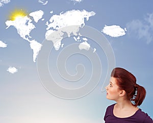 Young girl looking at world clouds and sun on blue sky