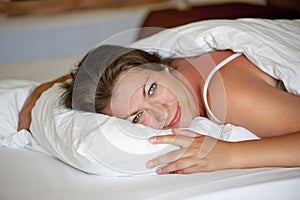 Young girl luxuriating in bed