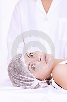 Young girl lying down ready to get a cosmetic