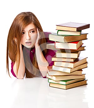 Young girl is lying on a floor and reading book