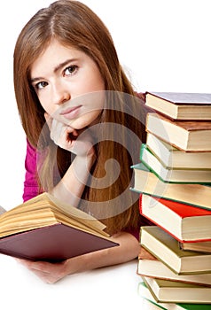 Young girl is lying on a floor and reading book