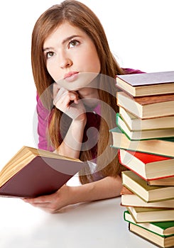 Young girl is lying on a floor and reading book