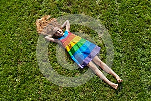 Young girl on lying on freshly mowed lawn