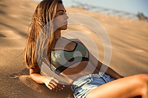 Young girl lying on a sand dune