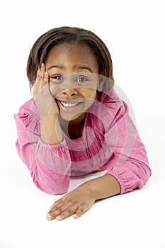 Young Girl Lying On Stomach In Studio