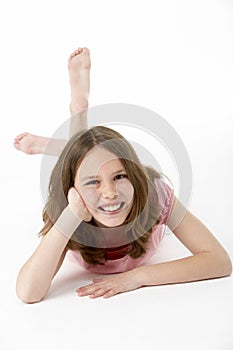 Young Girl Lying On Stomach In Studio