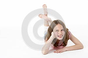 Young Girl Lying On Stomach In Studio