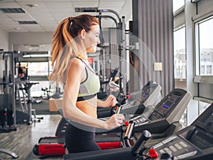 Young girl makes exercises at the gym