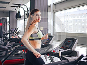 Young girl makes exercises at the gym