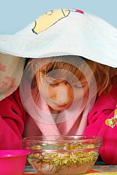 Young girl making inhalation photo