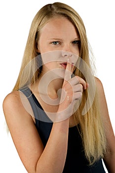 Young girl making silence gesture