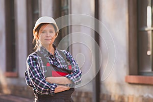 Young girl, manual worker posing outdoors with hands folded on chest