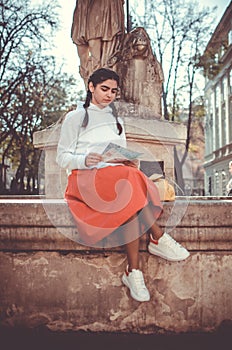 Young girl with map on a sightseen tour