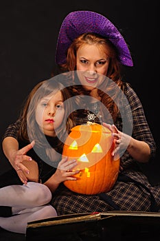 Young girl and mature mother at Halloween party