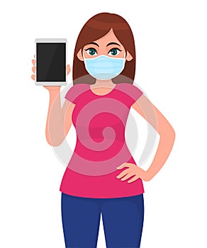 Young girl in medical face mask showing tablet computer. Woman holding digital gadget or pad. Female character. Corona virus