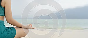 Young girl meditating at the sea for silence and relaxation Close-up in Gyan Mudra hand, woman doing yoga by sea, concept of