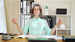 Young girl meditating in zen pose in office and ignoring angry boss