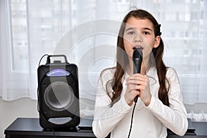 Young girl with a microphone singing