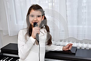Young girl with a microphone singing