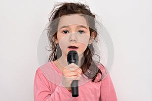Young girl with a microphone singing