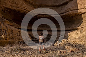 Young girl in the middle of the canyons of the Namibe Desert. Africa. Angola