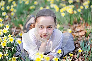 Young girl in the middle of daffodils