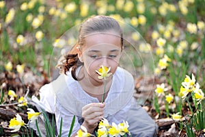 Young girl in the middle of daffodils