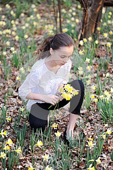 Young girl in the middle of daffodils