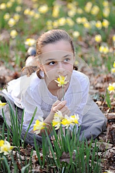 Young girl in the middle of daffodils