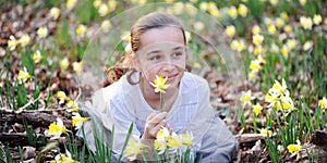 Young girl in the middle of daffodils