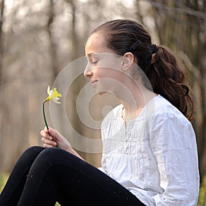 Young girl in the middle of daffodils