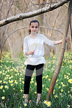 Young girl in the middle of daffodils