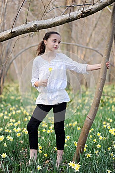 Young girl in the middle of daffodils