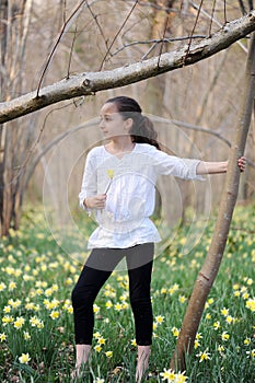 Young girl in the middle of daffodils