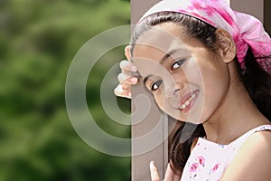 young girl of mix parentage on a garden terrace