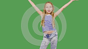 Young girl model posing front camera on green background. Girl teenager smiling and looking to camera on photo session