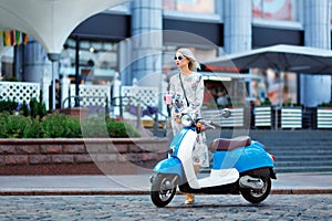 Young girl on a moped in the city