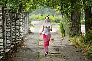 Young girl during a morning jog in the Park. Sport.